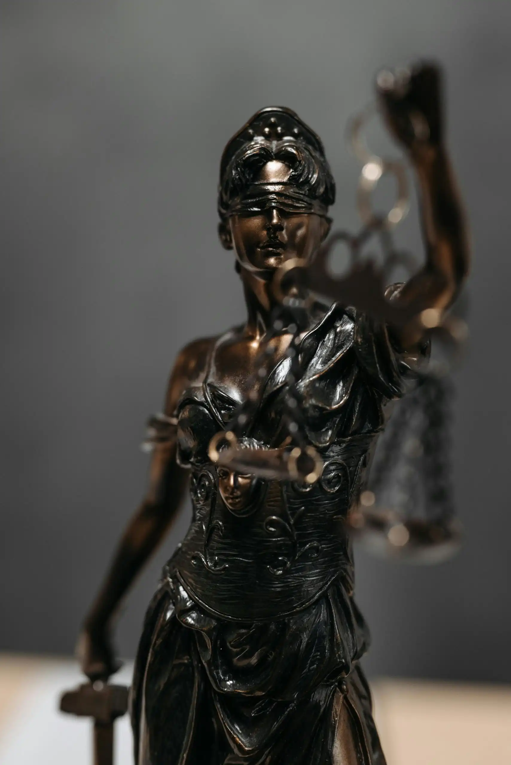 Bronze statue of Lady Justice wearing a blindfold, holding scales in one hand and a sword in the other, symbolizing impartiality and fairness—values at the heart of seeking justice in wrongful death cases. - Ghassemi Law Group Bronze statue of Lady Justice wearing a blindfold, holding scales in one hand and a sword in the other, symbolizing impartiality and fairness—values at the heart of seeking justice in wrongful death cases