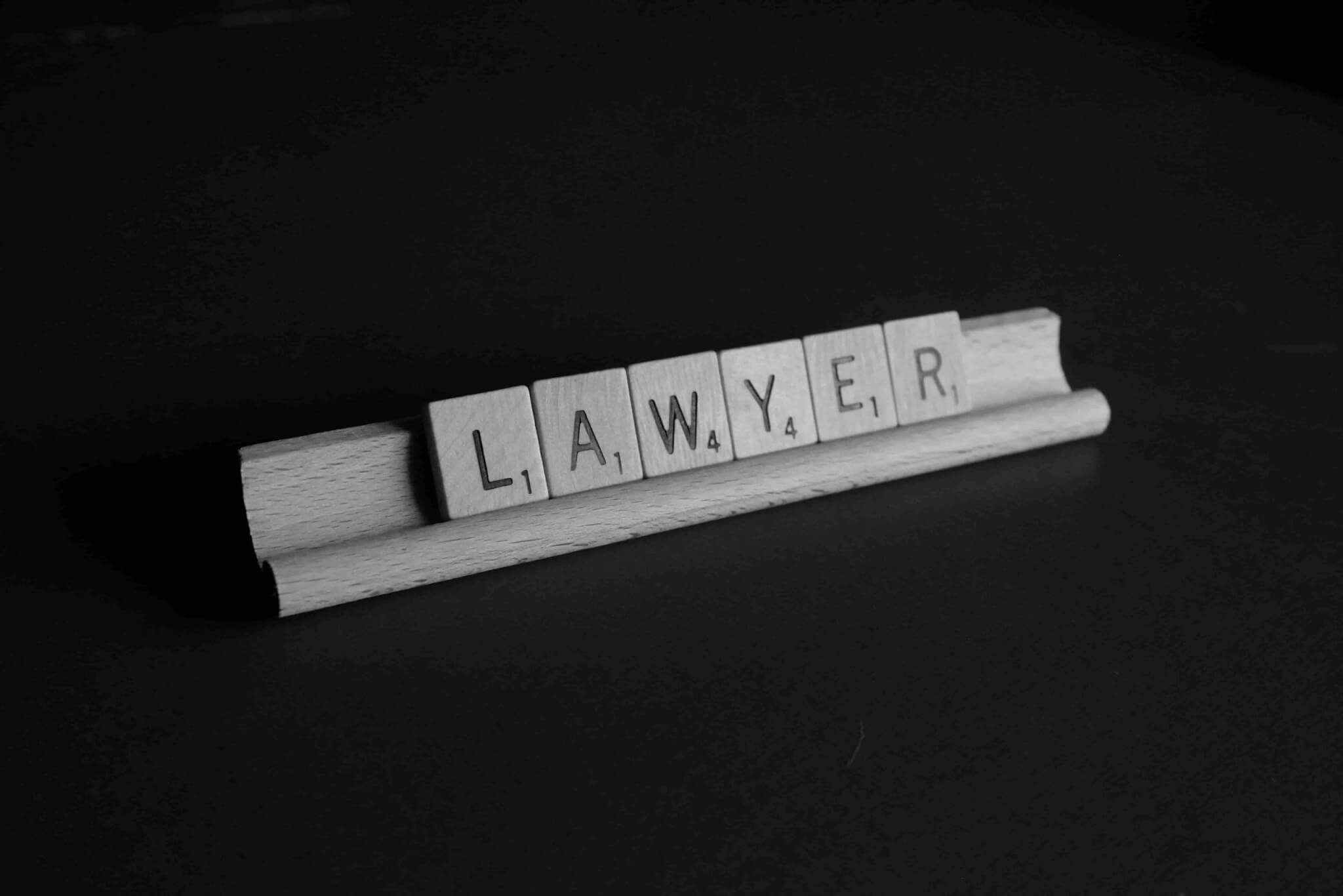 Letter tiles on a rack spell out the word "LAWYER" against a dark background, subtly prompting viewers to consider: When to Hire a Personal Injury Lawyer?. - Ghassemi Law Group Letter tiles on a rack spell out the word "LAWYER" against a dark background, subtly prompting viewers to consider: When to Hire a Personal Injury Lawyer?.