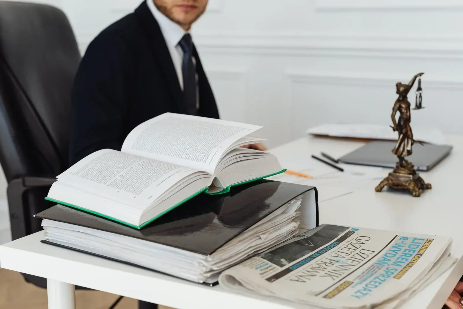 Legal reference book and case binder on an office desk